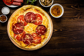 Pizza with salami, mushrooms and vegetables