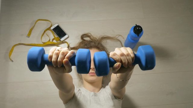Fitness mature woman working out with dumbbells. Healthy lifestyle