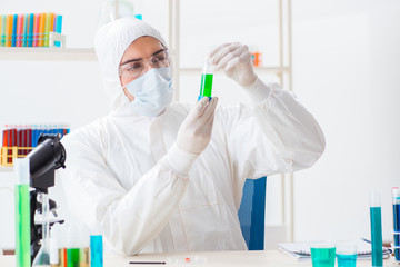 Young chemist student working in lab on chemicals