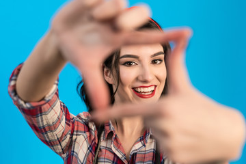 Obraz premium The cute woman gesturing on the blue background