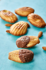 Yummy almond cookies arranged on blue background, close-up, selective focus, top view.