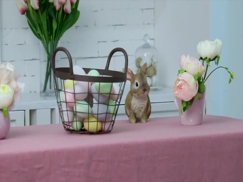 Painted eggs in a basket and Easter bunny