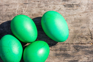 Painted Easter eggs on rustic wooden background