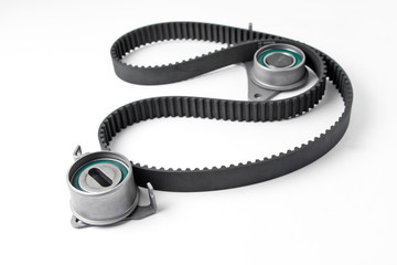 Naklejka premium Spare parts for the ca r. Kit of timing belt with rollers on a light background.