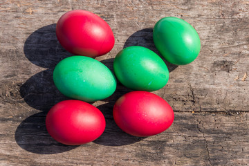 Painted Easter eggs on rustic wooden background