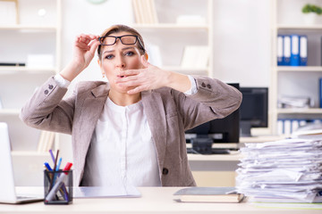 Businesswoman very busy with ongoing paperwork