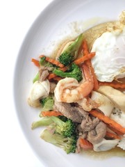 Mixed vegetable stir-fried with shrimp, pork and chicken with rice and fried egg in white plate. Vegetarian or healthy food concept. Favorite Chinese main dish recipes. vintage filter.