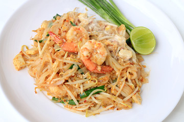 Thai style noodles, Pad Thai, stir-fried rice noodles with shrimp serve with vegetable in white plate on white background. The one of Thailand's national main dish. the popular food in Thailand.