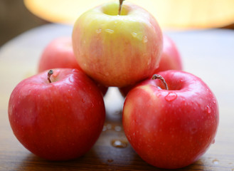Red apples on wooden background