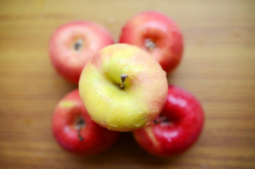 Red apples on wooden background