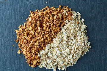 Obraz na płótnie Canvas Healthy mix of granola and oatmeal on dark background, top view, close-up, selective focus