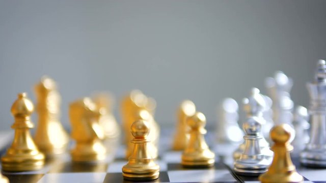 Close up shot hand of man and woman play gold and silver chess metaphor business compettition concept select focus shallow depth of field