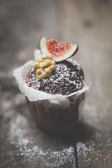 Delicious chocolate muffin on wood background
