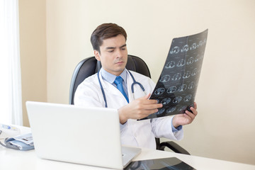 Portrait of Dooctor holding films x-ray and checking at hospital. People with medical concept.