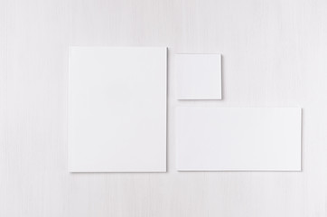 White blank envelope, letterhead, stickers on soft white wood board. Mock up for branding, business presentations and portfolios.