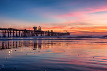 California Oceanside pier over the ocean at sunset with beach, travel destination - 197843428