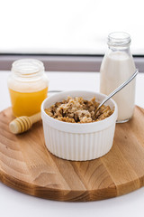 healthy breakfast fresh cereal,  milk bottle and honey jar