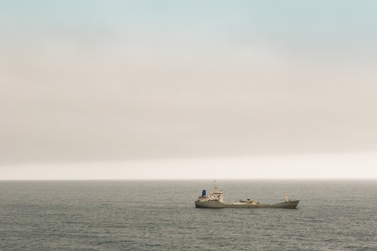 Water peaceful landscape with one bark on the Atlantic Ocean