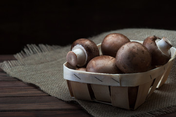 Champignon mushrooms on wooden background