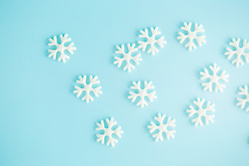 Fototapeta na wymiar Plastic toy snowflakes on a Blue sky Background.