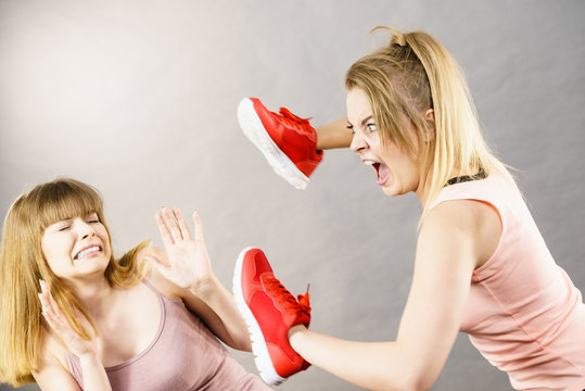 Women fighting with shoes
