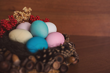 Easter eggs in the beautifyl nest on the wooden table