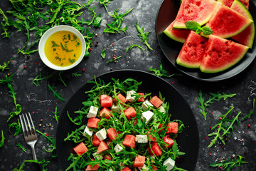 Fresh Juicy Watermelon arugula Feta salad with mint and orange, lemon dressing. summer dish. healthy food