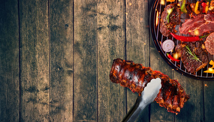 Top view of ribs and fresh meat and vegetable on grill © Jag_cz