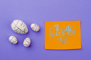 Happy Easter card and festive eggs. Styrofoam decorative eggs and card with text happy Easter. Congratulation with Easter holidays.