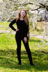 Young beautiful girl dressed in black jacket and black pants.