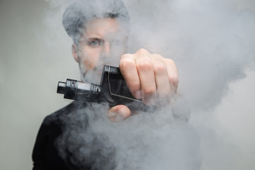 Vaping man and a cloud of vapor