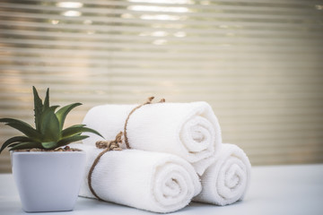 Beautiful spa composition white towel on wooden table.