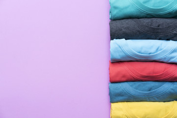 close up of rolled colorful clothes on purple background