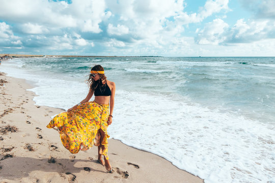 Boho girl walking on the beach