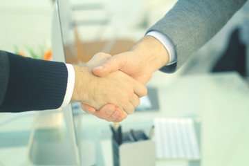 closeup .the financial partners shaking hands over a Desk