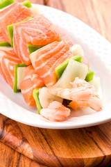 raw skewer of salmon prawns and vegetables