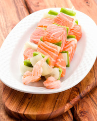 raw skewer of salmon prawns and vegetables