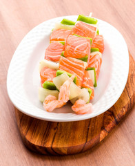 raw skewer of salmon prawns and vegetables