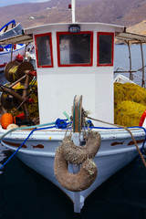 A close up of some small wooden colorful fishing boats at the port of Aegiali