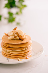 Banana cashew pancakes with bananas and caramel sauce.