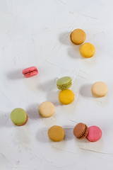 Macaroons isolated. Blue, rose and baige colors. White plate, white background.