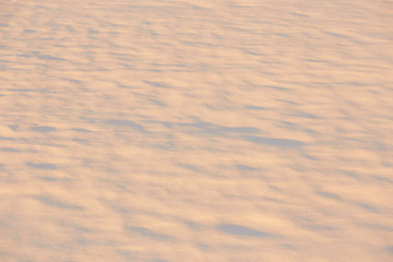 light and shadow on the snow in the golden hour. background.