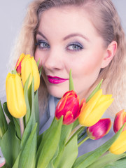 Pretty woman with red yellow tulips bunch