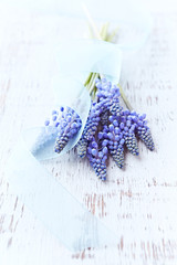 Grape Hyacinth Flowers on Rustic Wooden Background