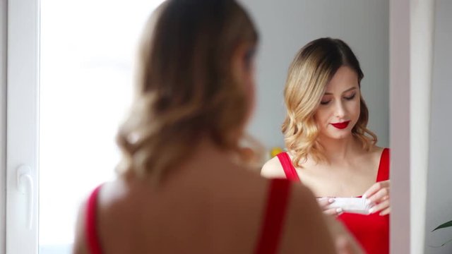 Young redhead woman eating a cake