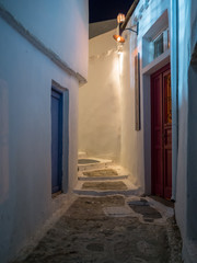 A small alley near the castle of Chora with soma colorful doors at night