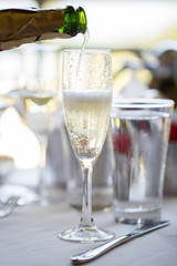 A man pours champagne in a glass