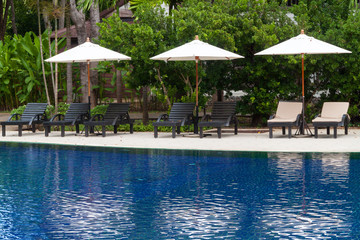 Bed and sofa at swimming pool side