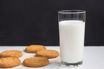 glass of milk and Freshly baked oatmeal cookies