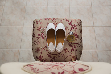 Bride's shoes with crystals stand on  chair